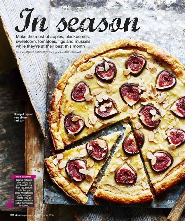 Creative food photography showing a fig and curd cheese tart decorate with figs and almonds, sliced and ready to serve