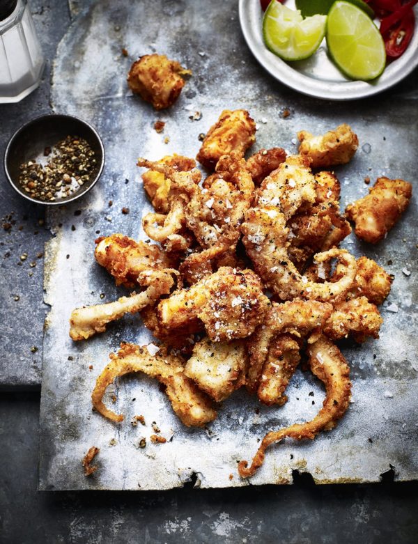London food photography shows deep fried octopus spread on a metal board with pepper spread on top