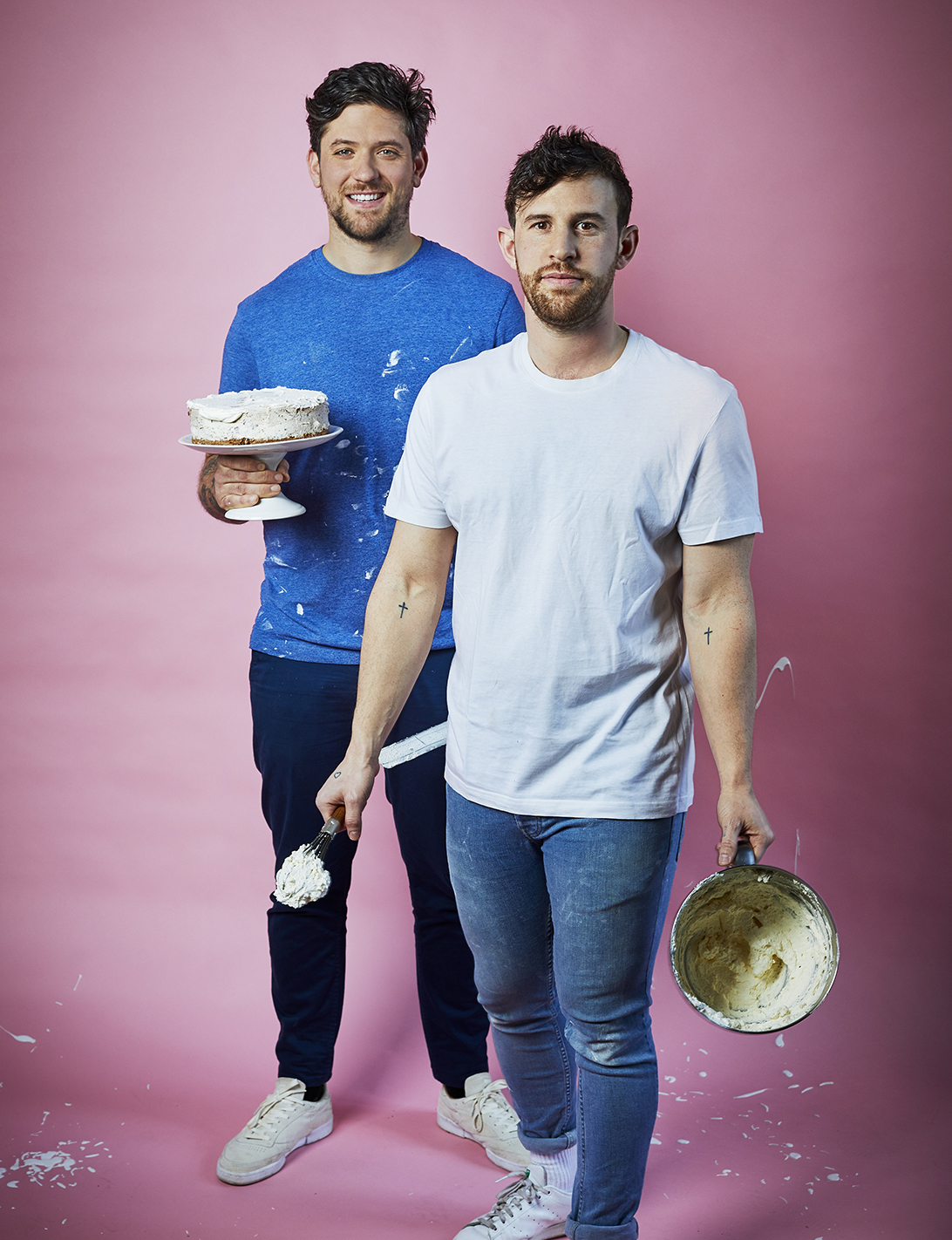 Food photography showing two men, one with a completed cake and the other with a mixing bowl