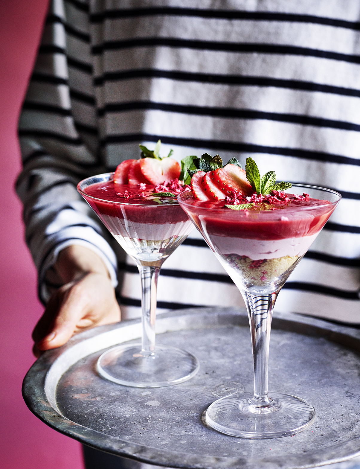 Food photography showing a person holdong a tray of two dacquiri cocktails